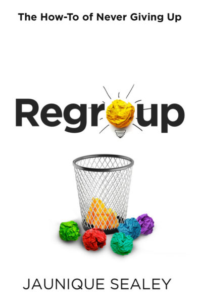 The clean and beautiful book cover of Regroup: the How-To of Never Giving Up shows brightly colored paper balls surrounding a metal mesh wastebasket. It depicts a bright idea as a vibrant yellow paper ball that also serves as the letter 